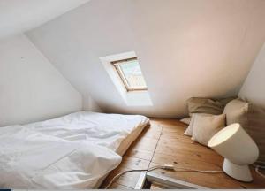 a bedroom with a white bed and a window at Apartment with Loft & Window Balcony, Free parking in Bergen