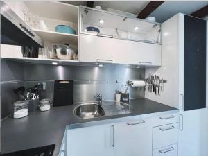 a kitchen with white cabinets and a sink at Apartment with Loft & Window Balcony, Free parking in Bergen +9 photos