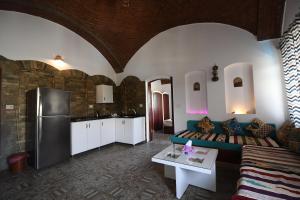 a living room with a couch and a refrigerator at Yasmine Guest House in Luxor