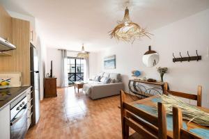 a kitchen and living room with a couch and a table at Apartamento La Falúa in Lajita +9 photos