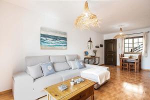 a living room with a white couch and a table at Apartamento La Falúa in Lajita