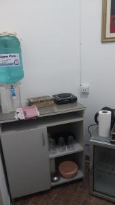 a kitchen with a table with a shelf with food at Gustavo in Villa Mercedes