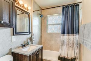 a bathroom with a sink and a tub and a window at 4 Mi to Museum of the Great Plains Lawton Home! in Lawton +19 photos