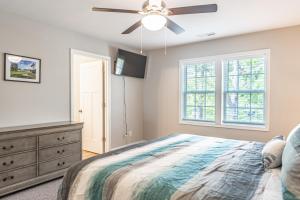a bedroom with a bed and a ceiling fan at River Birch at Ducks Landing in Aberdeen