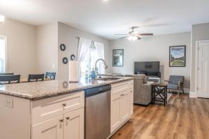 a kitchen with a counter top and a living room at The Dogwood at Ducks Landing in Aberdeen +15 photos