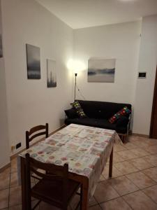 a living room with a table and a couch at FARE BnB - Room Porta Castello in Reggio Emilia +11 photos