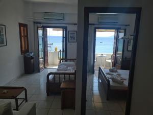 a room with two beds and a view of the ocean at Beach House Antonis Avlakia in Avlákia
