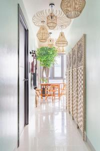 a dining room with a table and a chandelier at Tree of Life Penthouse 3BR w Gym Pool Sauna More in Manila