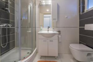 a bathroom with a sink and a shower and a toilet at Melanie in Crikvenica +46 photos