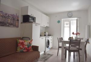 a living room with a couch and a table and a kitchen at Dimora Vima in Monopoli