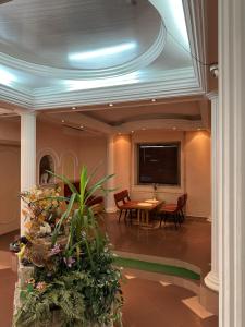 a lobby with a table and a tv on a ceiling at Vila Oaza in Bela Crkva