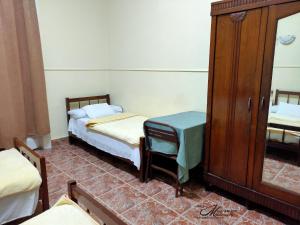 Postel nebo postele na pokoji v ubytování Triomphe Hostel