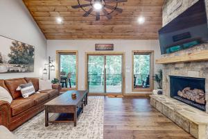 a living room with a couch and a fireplace at Rustic Elegance of Ellijay in Ellijay