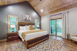 a bedroom with a large bed and a window at Rustic Elegance of Ellijay in Ellijay