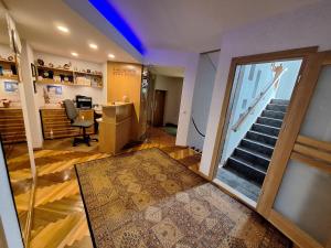 a room with a staircase and a desk with a chair at Home B&B in Kaunas