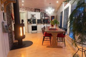 a kitchen and dining room with a table and chairs at Aaria Bed and Breakfast in Rovaniemi