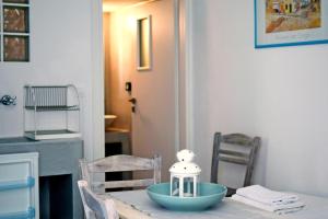 a table with a blue bowl on top of it at Thalassa4 in Andros