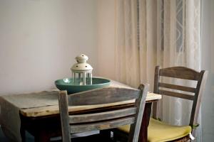a table with two chairs and a bowl on top of it at Thalassa4 in Andros