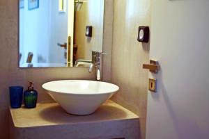 a white bowl sink on a counter in a bathroom at Thalassa4 in Andros +1 photo