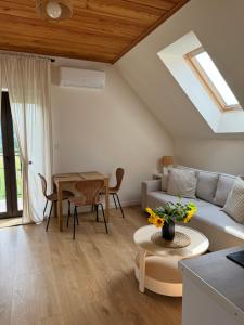 a living room with a couch and a table at Oaza Pieniny in Szczawnica