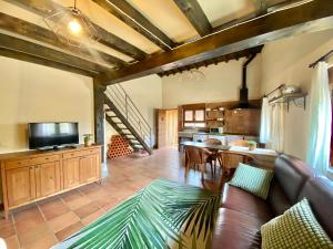 a living room with a couch and a dining room at Casa Pernila in Tábara