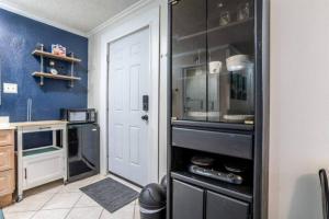a kitchen with a white door and a black cabinet at Pet-friendly Studio In Downtown Orlando Modern in Orlando