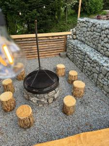 a fire pit with some logs and a bunch at Oaza Pieniny in Szczawnica