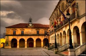 a building with a clock on the top of it at Hotel Soria Plaza Mayor in Soria