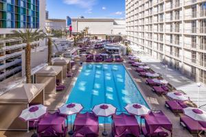 an overhead view of a pool with umbrellas and chairs at Harrah's Las Vegas, A Caesars Destination in Las Vegas
