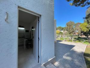 an open door of a white house with a patio at Habitación 2 personas Monte Hermoso in Monte Hermoso
