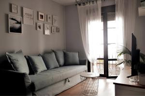 a living room with a couch and a window at Vivienda Uso Turistico Zapateria 1 licencia VUT 42120 in Soria