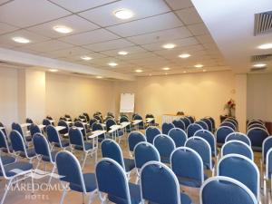 an empty room with chairs and tables and a podium at Maredomus Hotel in Fortaleza +47 photos