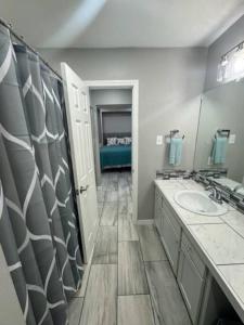 a bathroom with two sinks and a large mirror at Willow Ridge Cove in West Monroe +17 photos