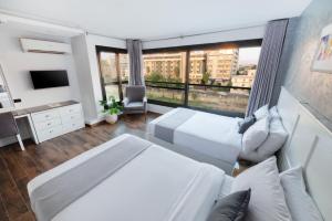 a large white bedroom with a large window at Nile Villa Hotel in Cairo