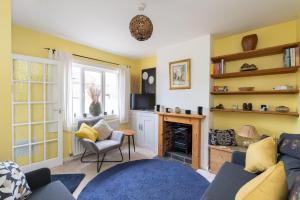 a living room with a couch and a fireplace at Quaint 3 bed Cottage in central Dorking with parking in Dorking