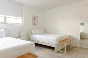 a white bedroom with two beds and a window at PROMO Komffy Apt with 2 Queen Beds & Ocean View at Tides 7th floor in Hollywood +34 photos