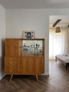 a wooden cabinet with glasses on it in a room at Śpimy u Dziadków - APARTAMENTY BIESZCZADY in Nowosielce Kozickie