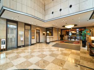 a lobby of a building with a large room at APA Hotel Takaoka Marunouchi in Takaoka