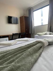 Postel nebo postele na pokoji v ubytování pousada praia bela japaratinga