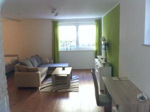 a living room with a couch and a table at Ferienwohnung Heike in Dettingen an der Erms