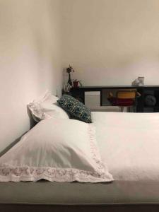 a bed with a white comforter and pillows on it at 19gradini in Putignano