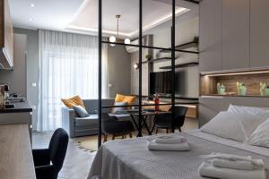 a bedroom with a bed and a dining room at La Casa Luxury Apartment in Xanthi