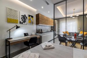 a kitchen and dining room with a desk and chairs at La Casa Luxury Apartment in Xanthi +16 photos