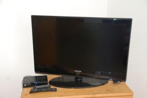 a computer monitor sitting on top of a wooden table at Haus Reiser in Alpirsbach