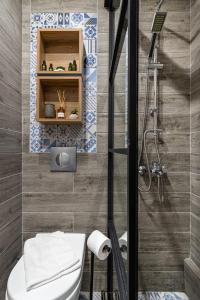 a bathroom with a toilet and a shower at La Casa Luxury Apartment in Xanthi