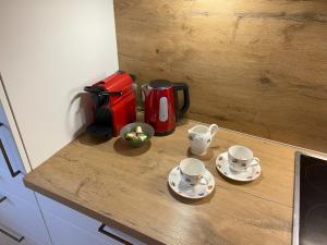 a kitchen counter with two cups and saucers on it at Plombergbauer in Sankt Gilgen