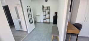 a hallway with a mirror and a table and a chair at Alex House in Făgăraş
