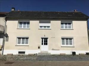 a large white house with a white door at Luna in La Coquille