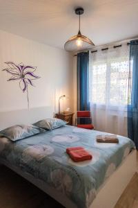 a bedroom with a large bed with two towels on it at Aux coquelicots sauvages in Pont-Saint-Martin +22 photos