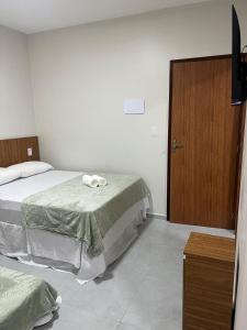 Postel nebo postele na pokoji v ubytování pousada praia bela japaratinga